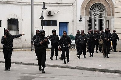 AFP file - Tunisian riot police arrive during a protest in Tunis.