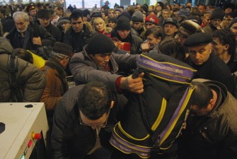 Passangers queue to pass security checks in Moscow's Domodedovo international airport on January 24, 2011. AFP