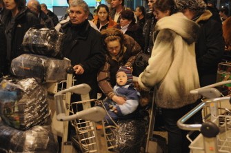 Passangers queue for a security check to enter Moscow's Domodedovo International Airport on January 24, 2011. AFP