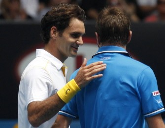 Federer pats Stanislas Wawrinka on the back after beating him on Jan. 25, 2011. AFP