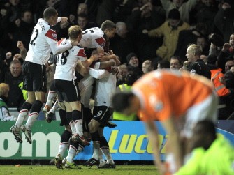 Manchester United players celebrate after their third goal during the match against Blackpool on January 25, 2011. AFP
