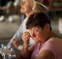 AFP file - A local woman (front) sits nearby Australian Govenor General Quentin Bryce (background) in the flodd-hit town of Grantham, Queensland.