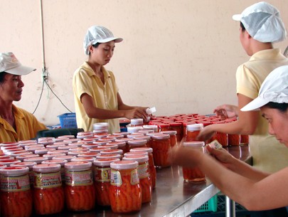 Workers in Hai Minh factory pack ca mam (preserved salted egg-plant) for exports