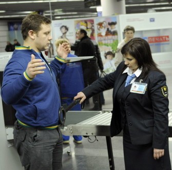 A guard uses a metal dectector on a passenger at a security checkpoint in Sochi airport, on January 25, 2011, a day after a bomb attack at Moscow's Domodedovo airport killed 35 people. AFP