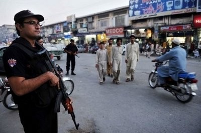 A Pakistani police commando, seen here standing guard in Peshawar.
