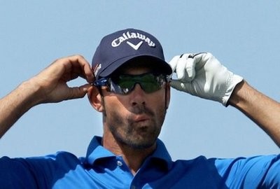 Alvaro Quiros adjusts his sunglasses before hitting a tee shot during the last round of the Dubai Desert Classic golf tournament in the Gulf emirate. AFP