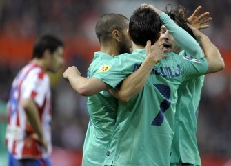 Barcelona's forward David Villa (C) celebrates with his team-mates after scoring against Sporting Gijon on February 12, 2011. AFP