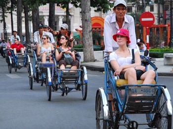 Foreign tourists enjoy Nguyen Hue Street in HCM City's downtown.