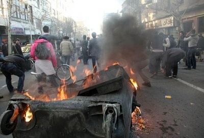 This photo, taken by an individual not employed by the Associated Press and obtained by the AP outside Iran shows Iranian protestors attending an anti-government protest as a garbage can is set on fire, in Tehran, Iran, Monday, Feb. 14, 2011.