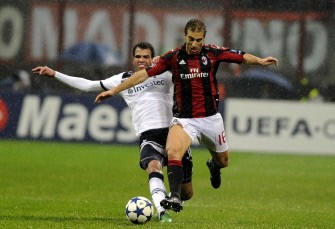 AC Milan's French midfielder Mathieu Flamini (R) fights for the ball with Tottenham Hotspurs' Brazilian player Cordeiro Sandro during their Champions League match on February 15, 2011 at San Siro. AFP