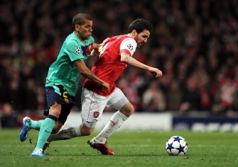Arsenal's Spanish midfielder Cesc Fabregas (R) vies with Barcelona's Brazilian defender Daniel Alves (L) during their Champions League round of 16, first leg match at the Emirates Stadium on February 16, 2011. AFP