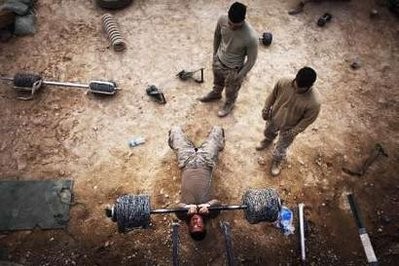 James Edward Orr, 20, from the First Battalion Eighth Marines Alpha Company lifts weights made from barbed wire at a makeshift gym at an outpost in Kunjak in southern Afghanistan's Helmand province, February 17, 2011