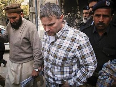 U.S. consulate employee Raymond Davis is escorted by police and officials out of court after facing a judge in Lahore in this January 28, 2011 file photo
