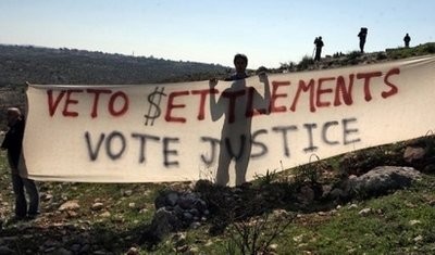 Palestinian protestors hold a banner during a demonstration in the West Bank.