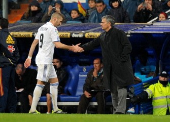 Real Madrid's forward Karim Benzema shake hands with coach Jose Mourinho after scoring against Levante during their Spanish league match at the Santiago Bernabeu Stadium, on February 19, 2011 in Madrid. AFP