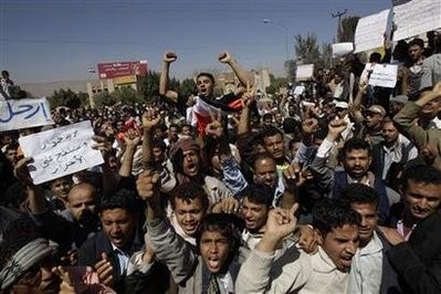 Anti-government protesters shout at government backers during a protest in Sanaa February 20, 2011