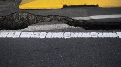 AFP file - Photo illustration shows cracked asphalt following a powerful earthquake.