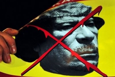 AFP - A banner featuring Libyan leader Moamer Kadhafi is seen as demonstrators stage a protest outside the Libyan embassy in Istanbul.