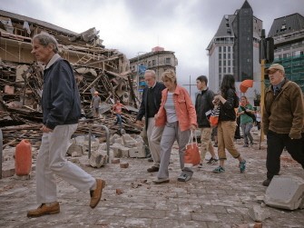 People walk through debris in the aftermath of the 6.3 magnitude earthquake in Christchurch, New Zealand, on February 22, 2011. AFP