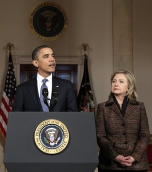 President Barack Obama, with Secretary of State Hillary Rodham Clinton at right, speaks about the situation in Libya in the Grand Foyer of the White House, Wednesday, Feb. 23, 2011, in Washington