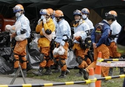 AFP - Relief workers from Japan are seen walking though the central earthquake zone in Christchurch, four days after a deadly quake rocked New Zealand's second largest city.