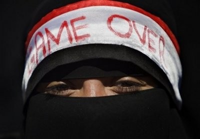 A veiled Yemeni woman wears a headband with the national colours and the phrase "game over" during an anti-government demonstration in the capital Sanaa. AFP
