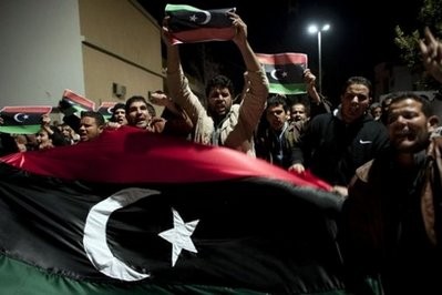 AFP - People hold former Libyan monarchist flags during a demonstration in the streets of Nalut, in western Libya