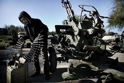 AFP file - A Libyan civilian hold anti-aircraft ammunitions at an army barrack in Benghazi