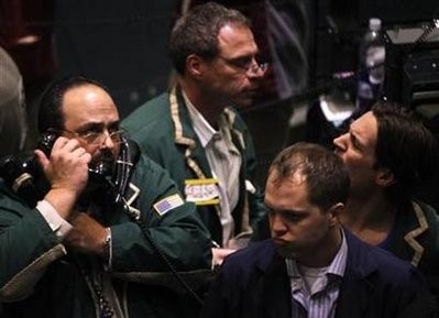 Traders work in the oil options pit on the floor of the New York Mercantile Exchange in New York, February 24, 2011