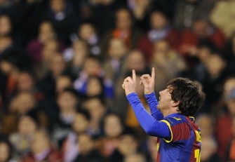 Lionel Messi celebrates scoring during the match against Valencia on March 2, 2011 in Valencia. AFP