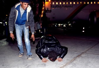 Egyptians who fled from Libya kiss the ground as they arrive from Djerba, Tunisia, on March 3, 2011 in the Cairo international airport in Egypt. AFP