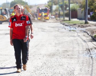 New Zealand Prime Minister John Key walks to survey earthquake damage in the Christchurch suburb of Bexley on March 4, 2011. AFP