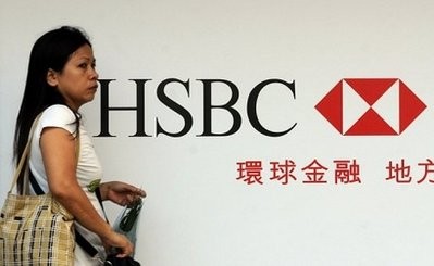 A woman walks past advertising for HSBC in Hong Kong. HSBC is considering quitting London for Hong Kong in a shock move, said The Sunday Telegraph newspaper