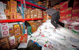 AFP - Workers re-stack supplies in the warehouse of the Mr T Asian food supermarket in Christchurch on March 6, 2011