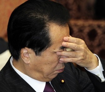 Japanese Prime Minister Naoto Kan covers his face with his hand during the Upper House's budget committee session at the National Diet in Tokyo on March 7, 2011, one day after his foreign minister Seiji Maehara resigned. AFP