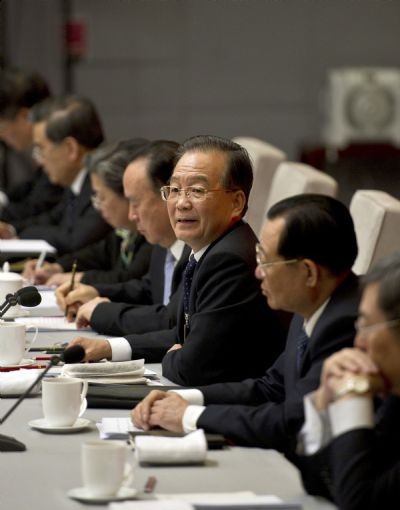 Chinese Premier Wen Jiabao (3rd, R), who is also a member of the Standing Committee of the Political Bureau of the Communist Party of China (CPC) Central Committee, joins a panel discussion with deputies to the Fourth Session of the 11th National People's Congress (NPC) from the circles of economy and agriculture in Beijing, capital of China, March 7, 2011