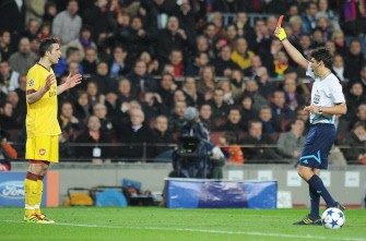Arsenal's Robin Van Persie (L) reacts after referee Massimo Busacca (R) gave him a red card. AFP
