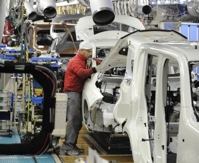 AFP file - A worker at Nissan Motors is seen installing components onto an electric vehicle at one of the auto giant's assembly lines in Yokosuka.