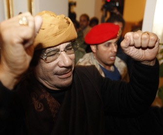 Moamer Kadhafi gestures as he arrives at the Rixos hotel in the capital Tripoli on March 8, 2011. AFP