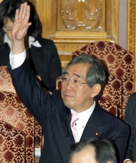 Takeaki Matsumoto raises his hand to answer a question at the Upper House's budget committee session at the National Diet in Tokyo on March 9, 2011. AFP