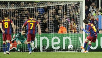 Messi (L) scores his second goal from a penalty kick. AFP