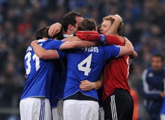 Schalke players celebrate after the UEFA Champions League Round of 16 second leg football match Schalke 04 vs FC Valencia. AFP