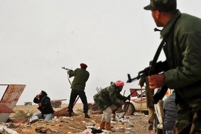 Libyan rebel fighters fire towards approaching Kadhafi regime tanks at the key Libyan oil town of Ras Lanuf.