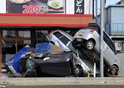 Cars damaged in the tsunami which hit northeast Japan sit piled on top of one another in Tagajo, Miyagi prefecture days after a massive 8.9 magnitude earthquake monster wave hit the region