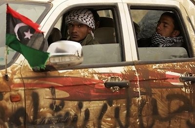 Libyan rebels drive on the western outskirts of Benghazi.