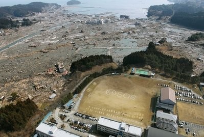 An SOS sign is written on the ground of Shizugawa High School in Minamisanrikucho in Miyagi Prefecture (state), northern Japan, Sunday, March 13, 2011, two days after the powerful earthquake and tsunami hit the area.