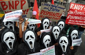 Anti-nuclear activists wearing masks hold a protest near the presidential palace in Manila on March 15, 2011 as they rally against the revival of the mothballed Bataan nuclear power plant (NBPP). AFP