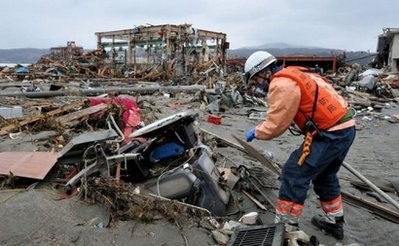 AFP - A rescue worker searches for missing residents in Minamisanriku, Miyagi prefecture on March 15, 2011.