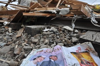 A magazine featuring Jaapanese Emperor Akihito and Empress Michiko is seen in the rubble in the devastated city of Ofunato on March 15, 2011. AFP