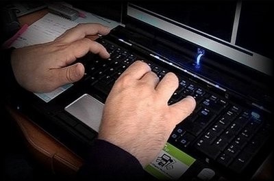 A photo made available by the Child Exploitation and Online Protection Centre shows a police officer tracking paedophile's on the Internet